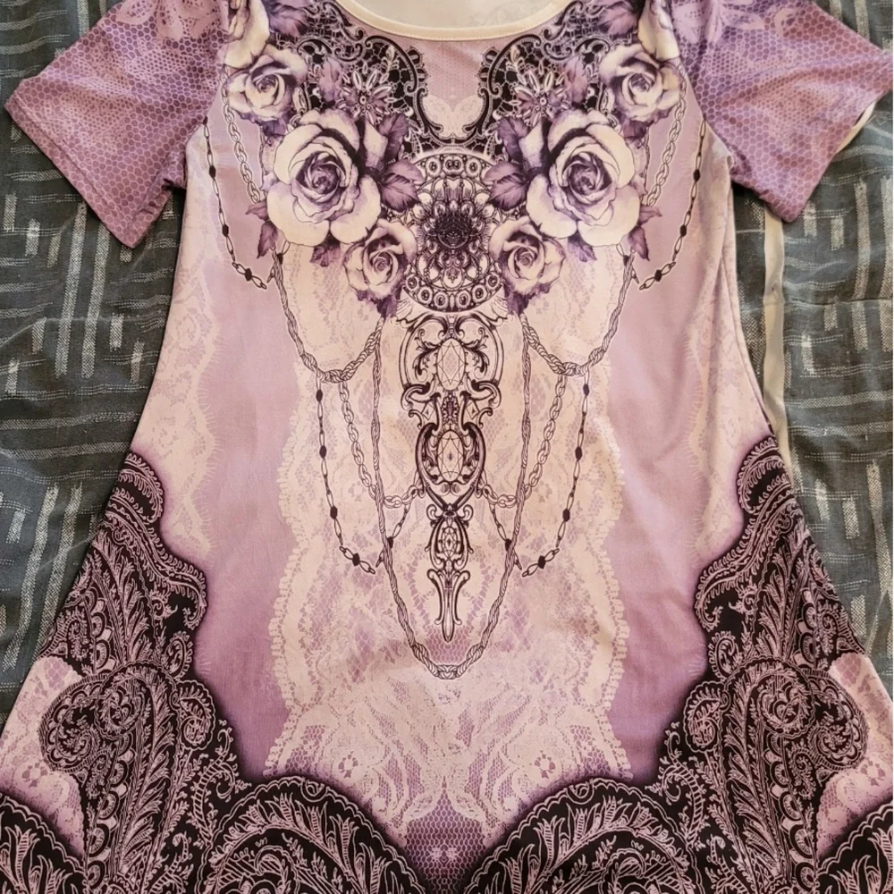 Short sleeve purple top with design. Material is loose fitting. - Picture 1 of 3